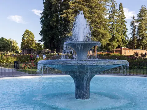 The fountain at the San Jose Municipal Rose Garden under tall trees