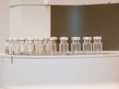 A row of clear glass vials in a laboratory