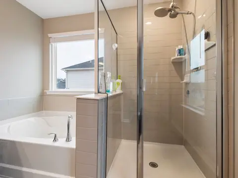 A bright bathroom with a soaking tub and a glass shower